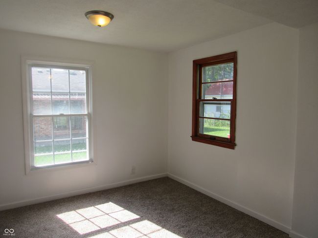 carpeted empty room featuring plenty of natural light | Image 9