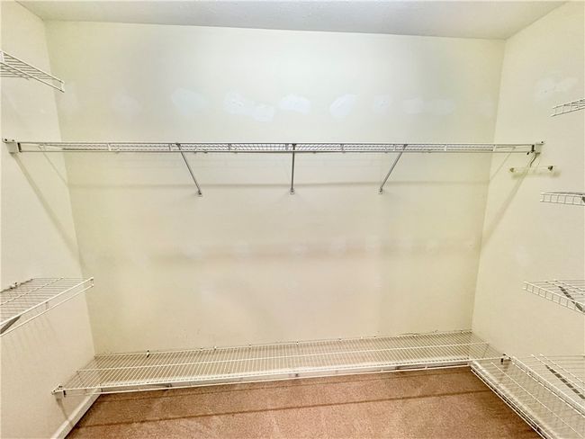 Walk in closet with shelving. | Image 14