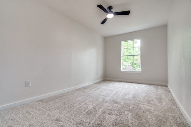 Carpeted empty room with ceiling fan and baseboards | Image 22