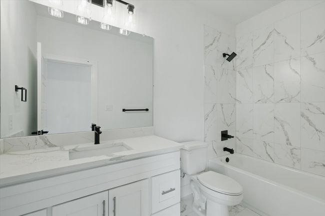 Bathroom with vanity, toilet, shower combination, and marble finish floors | Image 27