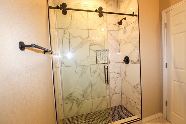 Full bathroom featuring a marble finish shower | Image 16