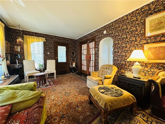 Unit 1 - Living room - looking towards the french doors that lead to the dining room, on the right. | Image 6