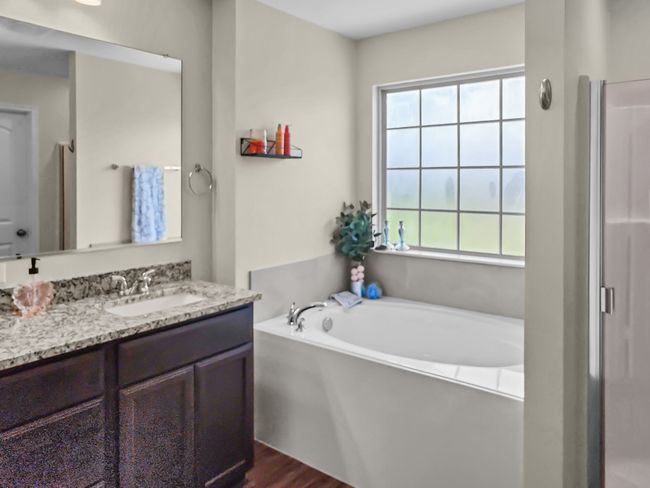 Full bathroom featuring vanity, a garden tub, and an enclosed shower | Image 19