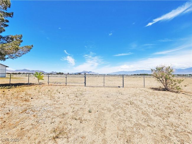 View of yard with a mountain view, a rural view, and fence | Image 34