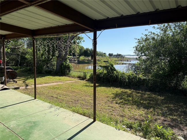 View of green lawn featuring a water view and a patio | Image 4