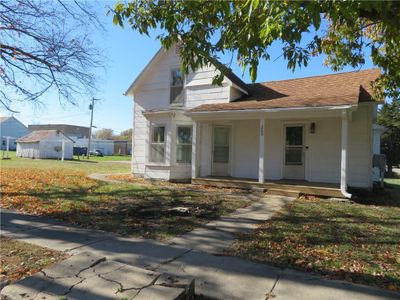 Bungalow featuring a front lawn and covered porch | Image 2