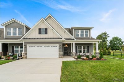 View of front facade with a front lawn and a garage | Image 1