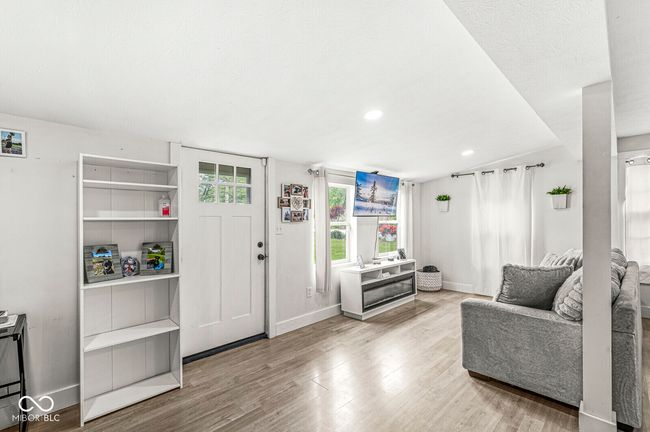 living area with baseboards, wood finished floors, and recessed lighting | Image 5