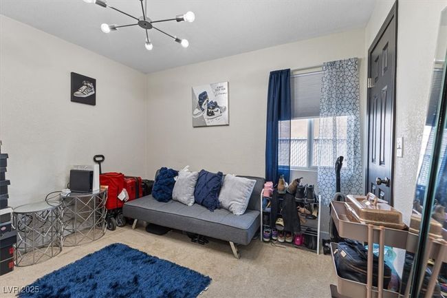 Living area with a chandelier and carpet floors | Image 21