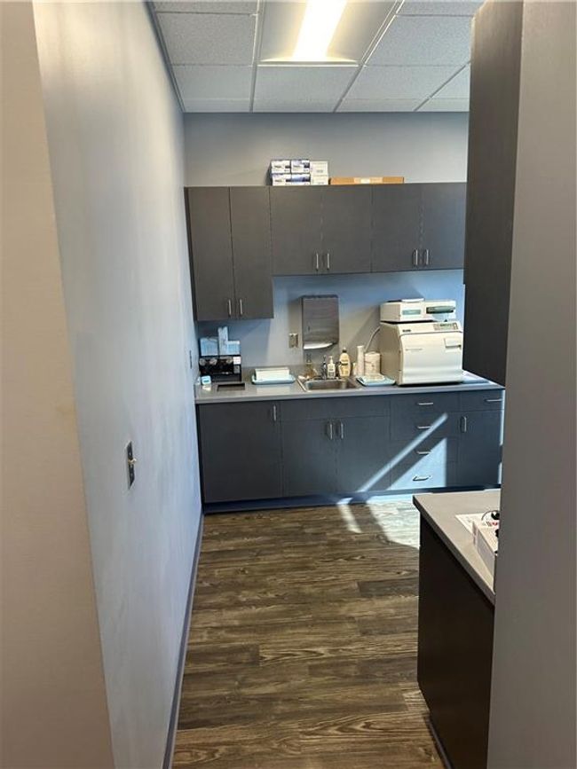 Kitchen featuring dark hardwood / wood-style floors, a drop ceiling, and sink | Image 11