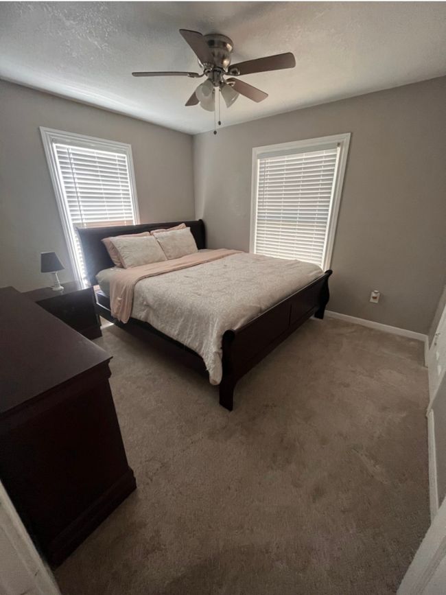 Carpeted bedroom featuring ceiling fan and baseboards | Image 4