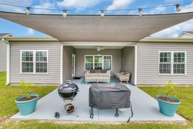 View of patio / terrace featuring ceiling fan, an outdoor hangout area, and a grill | Image 36