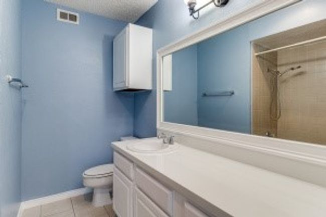 Bathroom featuring vanity, a shower, tile patterned flooring, and a textured ceiling | Image 13
