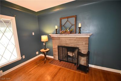 Distinctive vintage living room window design, attractive stone fireplace, cove ceiling | Image 3