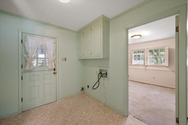 Washroom featuring cabinet space, hookup for a washing machine, healthy amount of natural light, light floors, and crown molding | Image 32