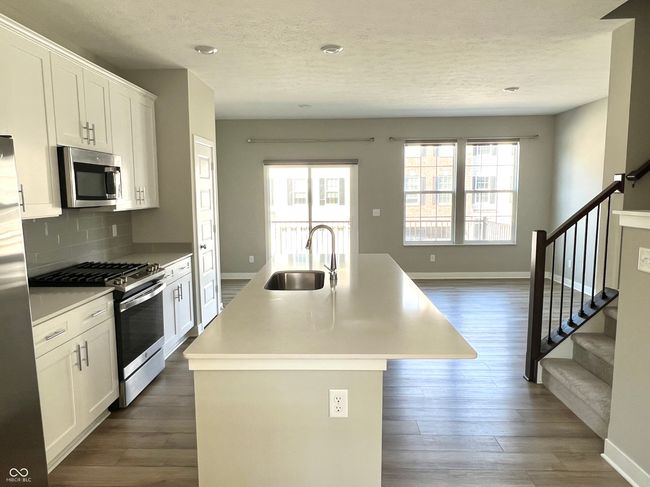 Gourmet chef's kitchen with SS appliances, gas range, Shelf Genie cabinet system, quartz countertops. Open to hearth room. | Image 15