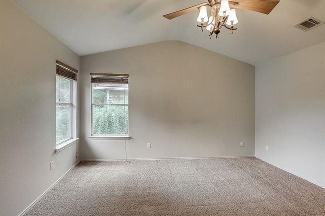 Empty room featuring ceiling fan, carpet, vaulted ceiling, and baseboards | Image 21