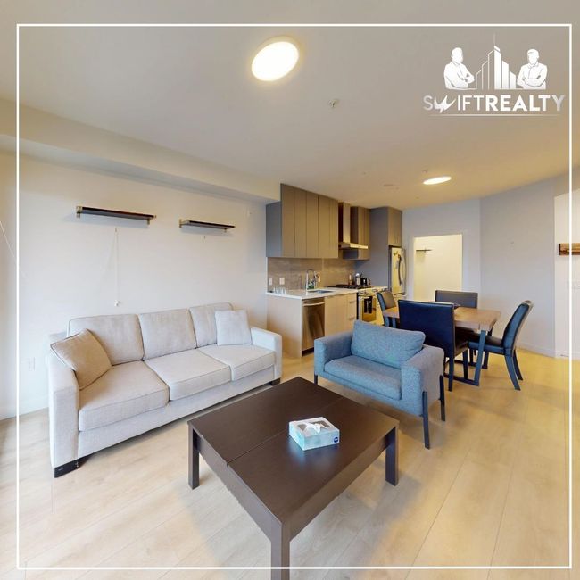 Living area with light wood-style floors | Image 4