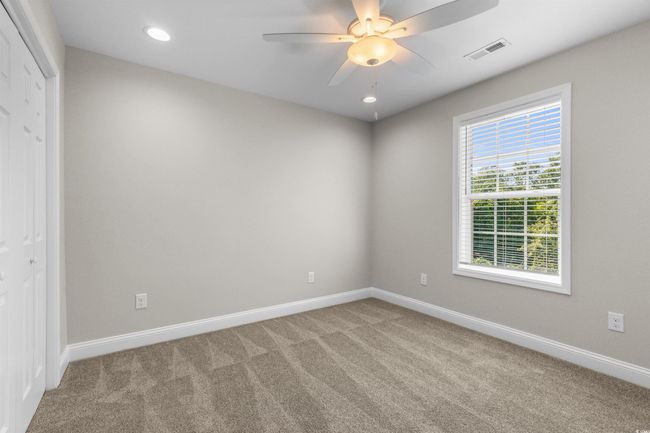 Unfurnished bedroom featuring carpet, baseboards, recessed lighting, ceiling fan, and a closet | Image 31