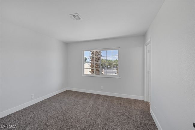 Unfurnished room featuring dark colored carpet and baseboards | Image 24