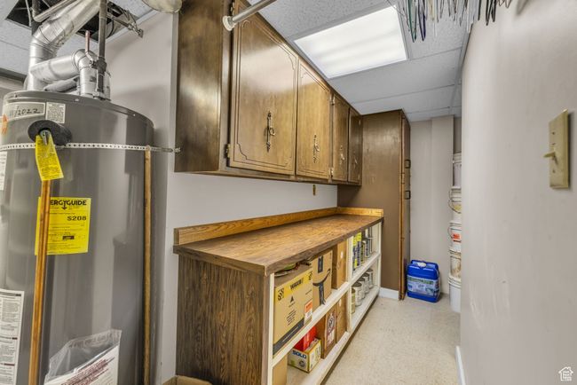 Basement with double water heaters, light floors, and baseboards | Image 30