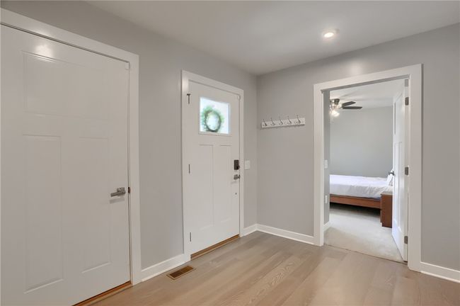 Modern and stylish entry with engineered hardwood floors greets you with warmth. | Image 9