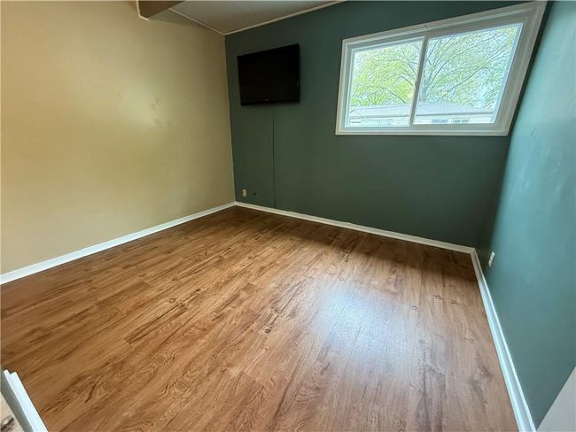 Empty room with wood finished floors and baseboards | Image 19