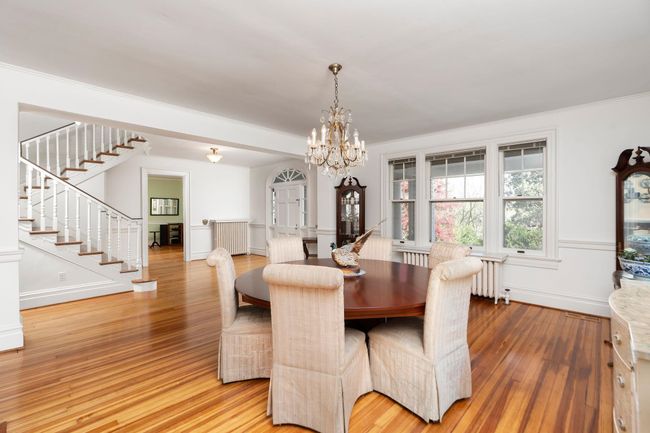 Entertain guests at this wonderful open dining area while overlooking the private grounds through the gorgeous leaded windows. | Image 10
