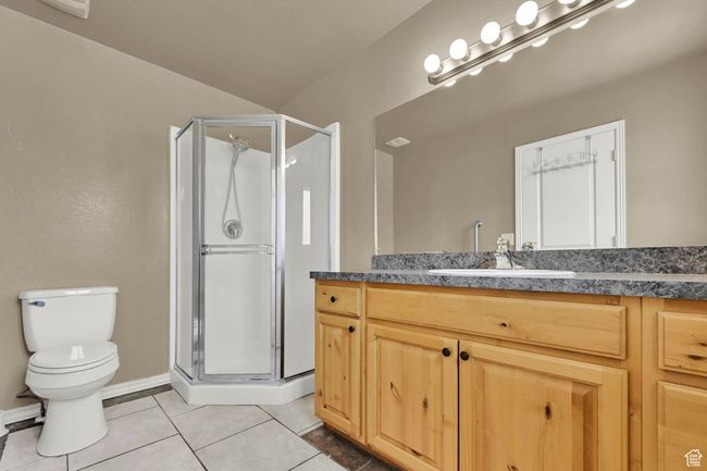 Bathroom featuring vanity, a shower stall, and tile patterned flooring | Image 14
