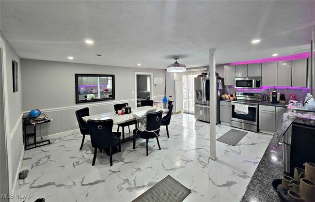 Dining room featuring recessed lighting, marble finish floor, and wainscoting | Image 22