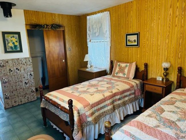 Bedroom featuring wooden walls | Image 11