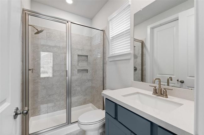 A well-appointed bathroom on the first floor, conveniently serving the second bedroom for easy access and added privacy. | Image 12