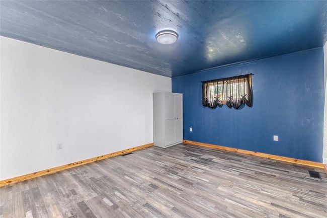 Spare room with wood finished floors and baseboards | Image 26