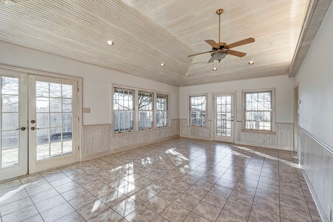 Sunroom, with motorized solar shades and tranquil views from every window! Perfect place for a pool table and a few bar height tables and stools! | Image 12