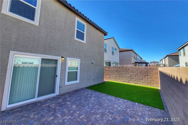 Back of house with stucco siding, a patio area, fence, a residential view, and a tiled roof | Image 21