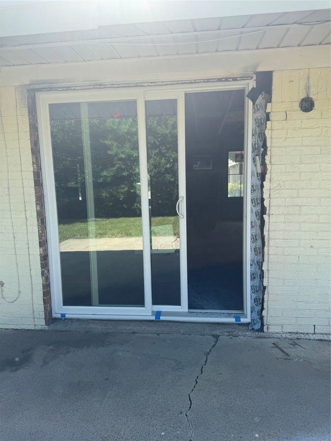 View of exterior entry featuring brick siding | Image 16