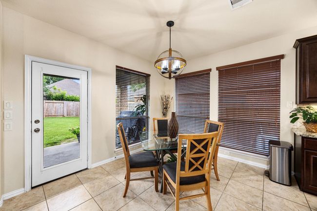 Plenty of windows and door to the back patio. | Image 16