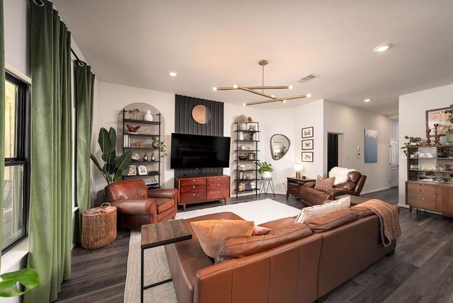 Living room has upgraded paint and the entry features a tiled drop zone and wall treatment | Image 7