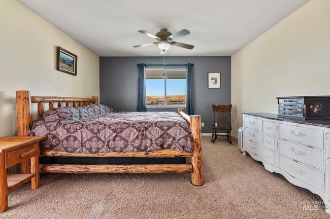 Primary Bedroom with light carpet , ceiling fan, door to exterior patio | Image 20