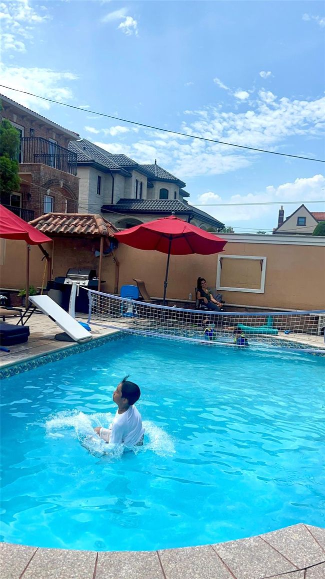 Outdoor pool featuring a diving board | Image 25