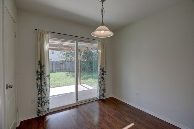 Empty room featuring baseboards and dark wood-style floors | Image 6