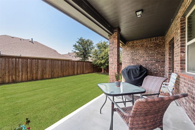 Fenced backyard featuring a grill | Image 34