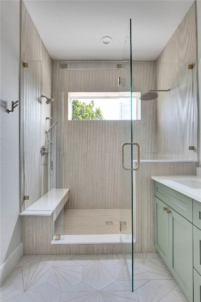 Bathroom featuring a stall shower, vanity, and tile patterned flooring | Image 32