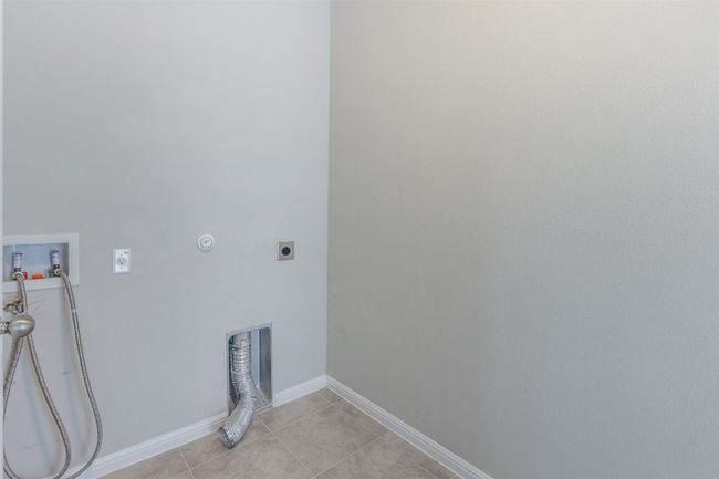 Laundry room with baseboards, washer hookup, laundry area, light tile patterned flooring, and electric dryer hookup | Image 31
