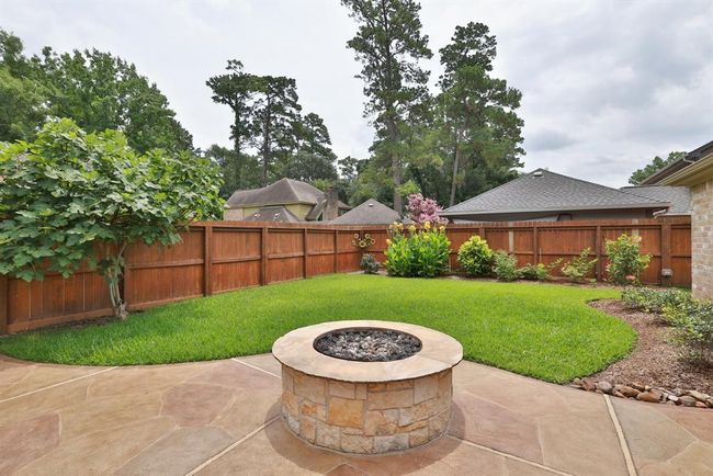 Beautiful built-in firepit is fun for backyard marshmallow roasts in the summer and cozy family get-togethers in winter. | Image 37