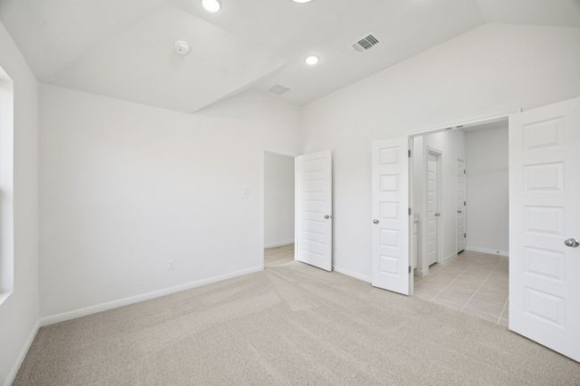 Unfurnished bedroom with vaulted ceiling, carpet floors, and recessed lighting | Image 21