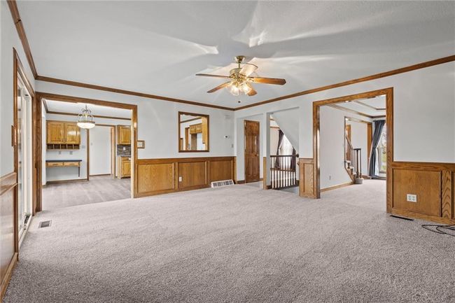 Carpeted spare room featuring ceiling fan and crown molding | Image 9