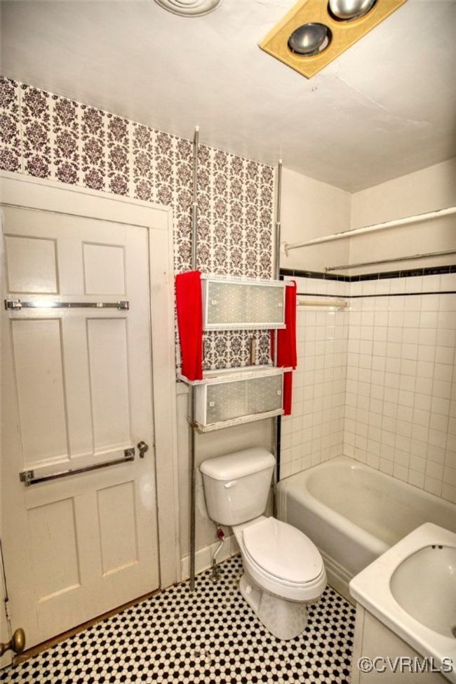 Bathroom with toilet, tile patterned floors, and shower / tub combination | Image 22