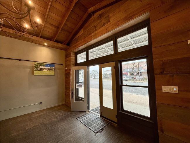 Doorway to outside featuring vaulted ceiling with beams, wood ceiling, and dark hardwood / wood-style floors | Image 9