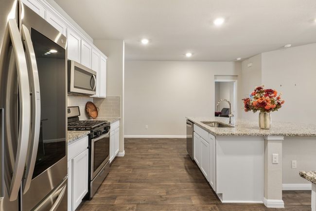 Light and bright kitchen with french door refrigerator. | Image 5